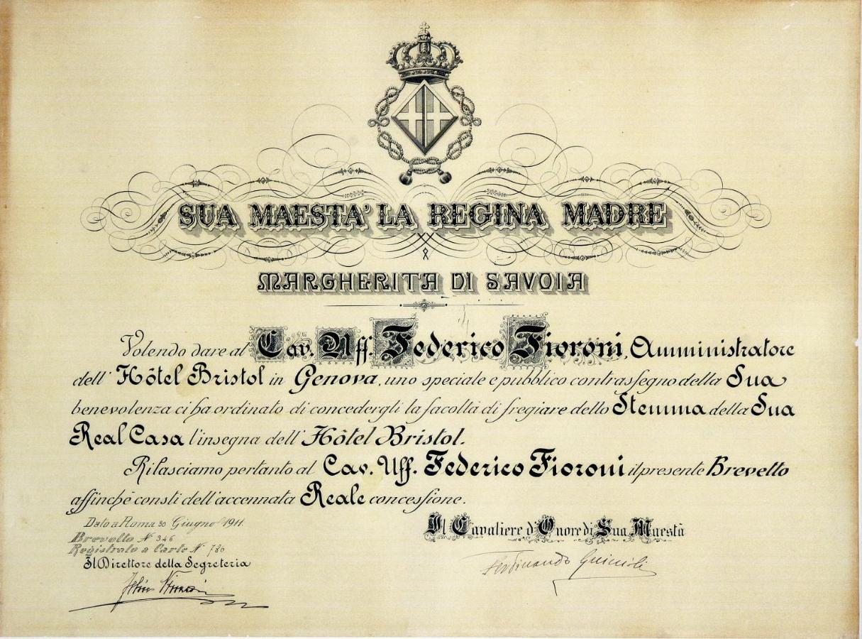 Hotel Bristol Palace Genova Esterno foto The image depicts an ornate certificate or document that appears to be an official acknowledgment or commendation. It is written in Italian and features a royal crown at the top. The document is addressed to "Sua Maestà la Regina Madre" (Her Majesty 